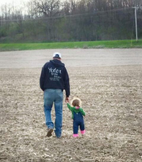 Dad and daughter walking in a field