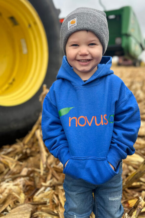young boy at harvest Novus Ag